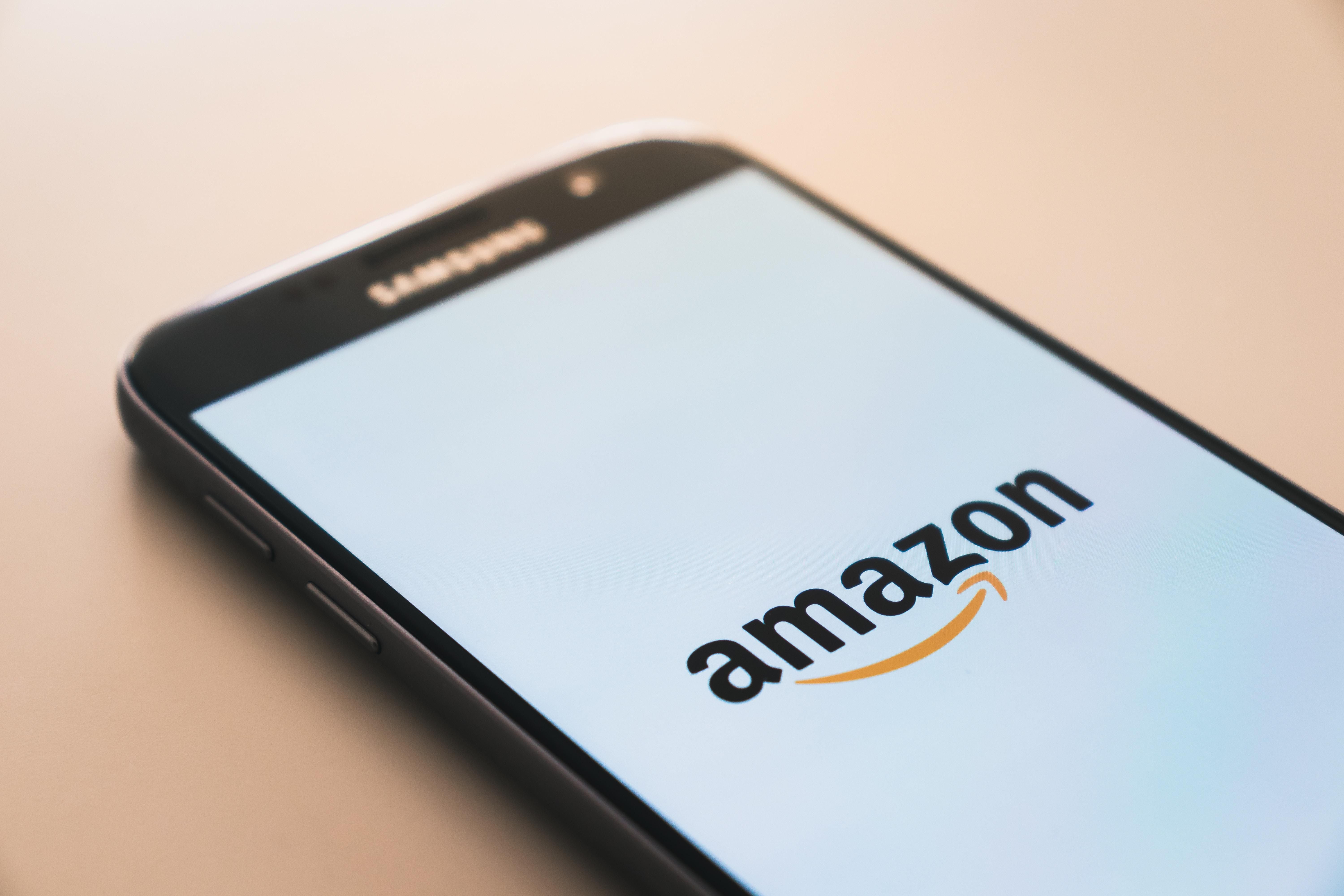 Amazon logó egy okostelefonon, ami az asztalon pihen
