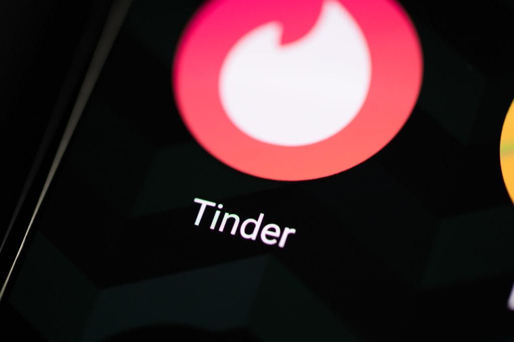 Tinder logó egy fekete okostelefonon