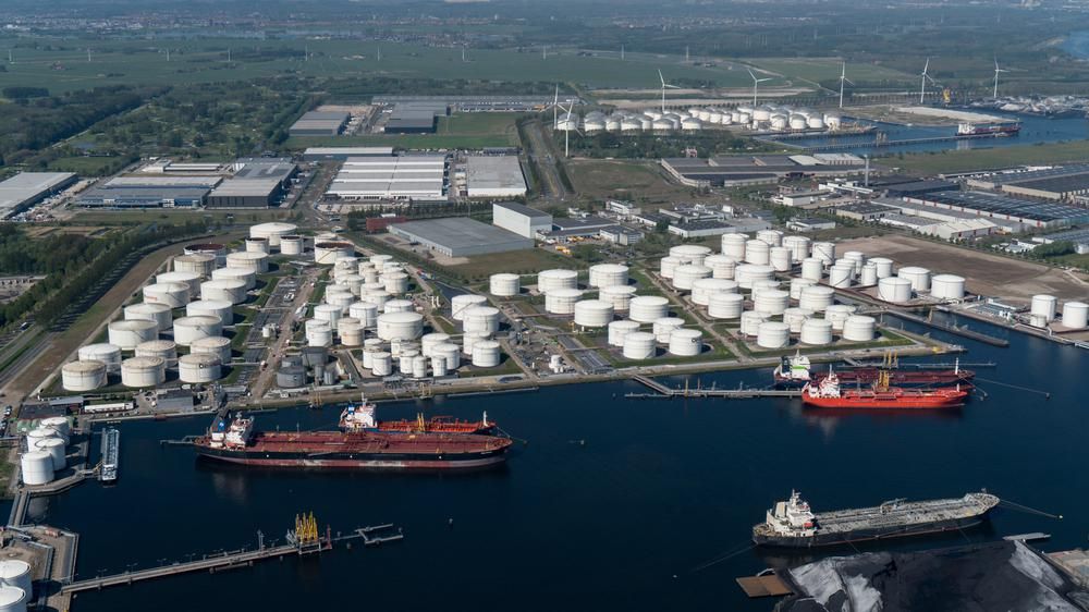 Az Oiltanking német olajvállalat egyik olajkikötője, fehér olajtárolók és teherhajók láthatók a képen