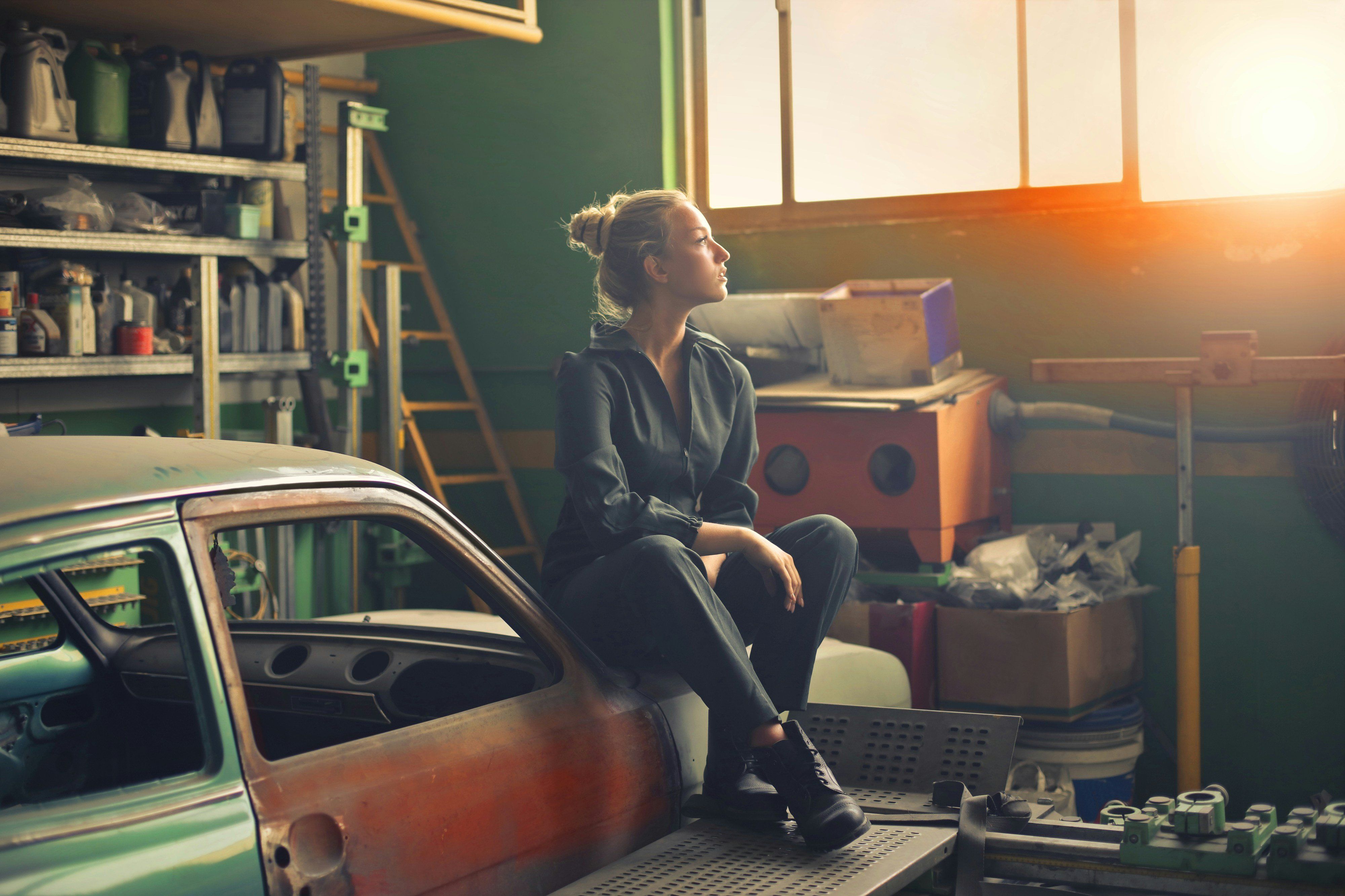 Fiatal lány egy autószerelő műhelyben