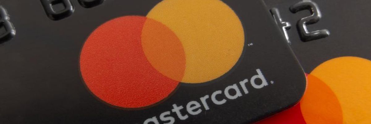 Két fekete Mastercard kártya, amelyeken a Mastercard piros-narancssárga logója és felirata látszódik
